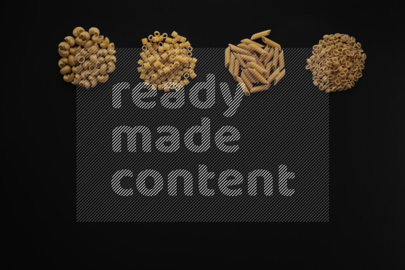 Different pasta types in 4 bunches on black background