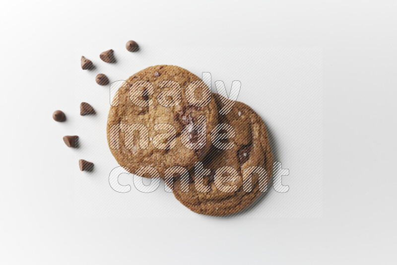 Chocolate chips cookies with chocolate beside it on a white background