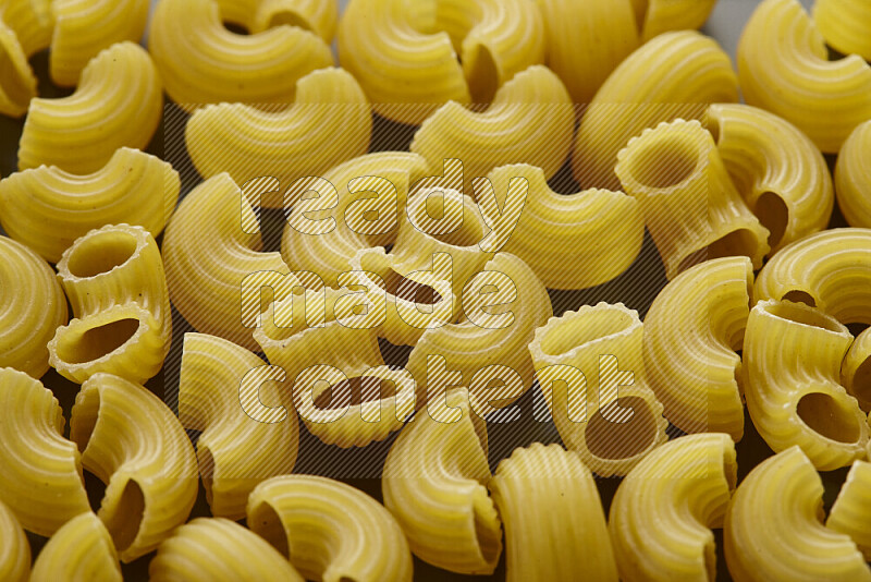 Elbow pasta on grey background