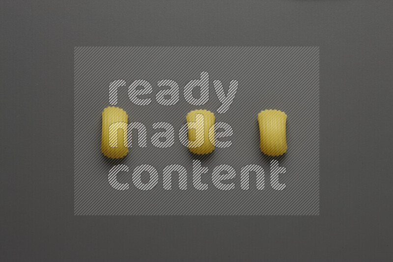 Elbow pasta on grey background