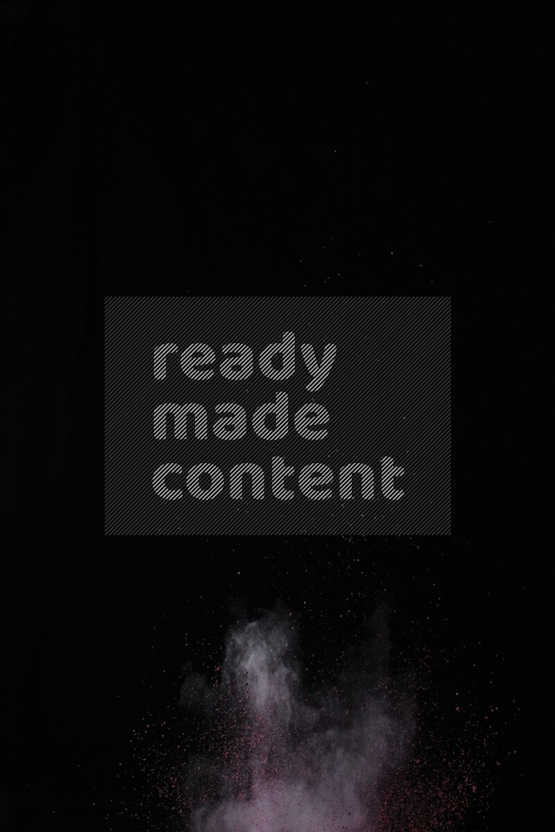 A side view of red powder explosion on black background