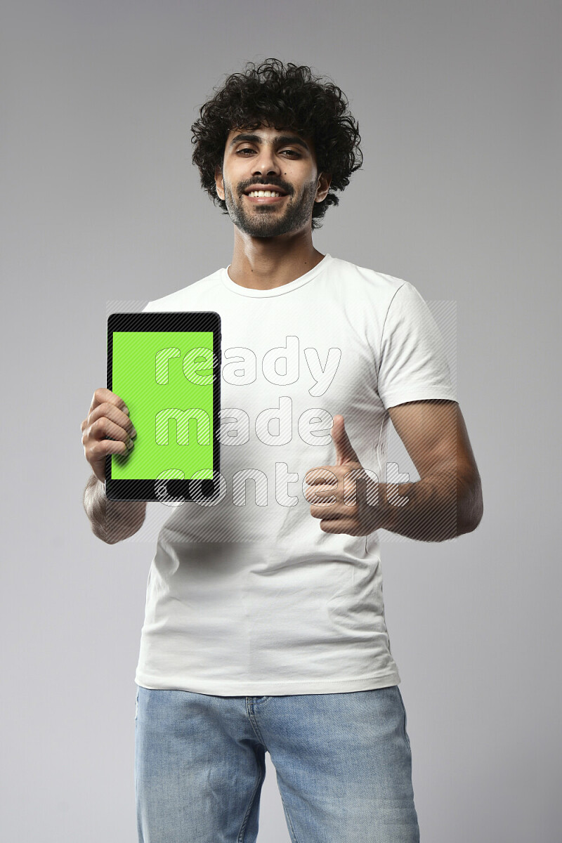 A man wearing casual standing and showing a tablet screen on white background