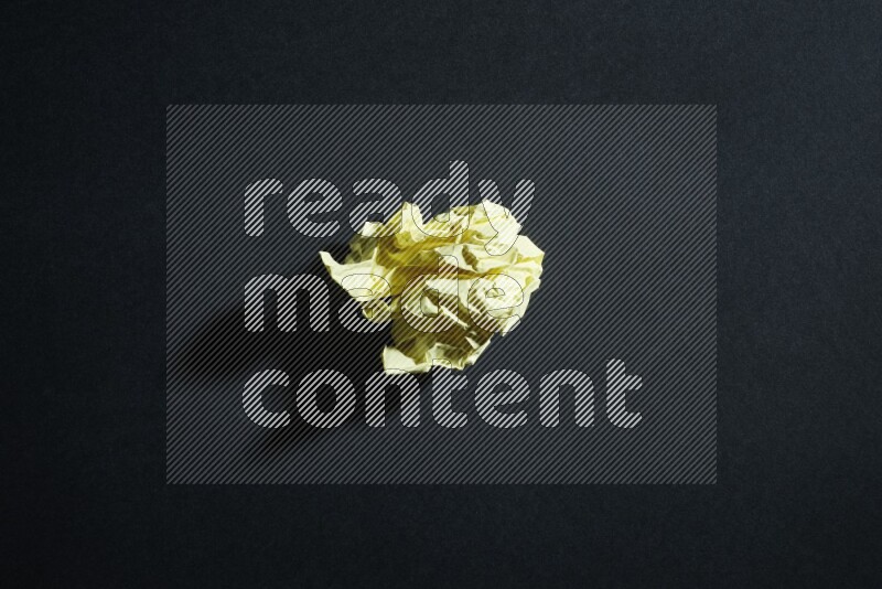 Yellow paper sheet on black background