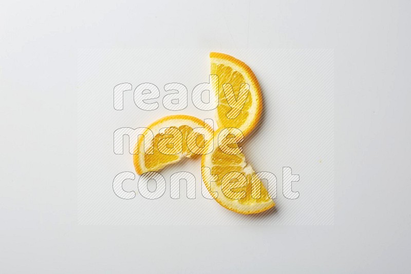 Three halves of an orange slices on white background