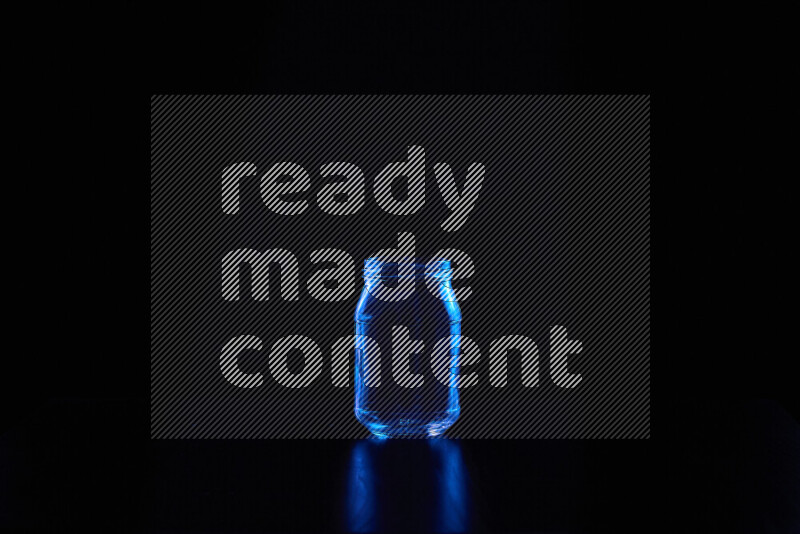 Glassware with rim light in blue against black background