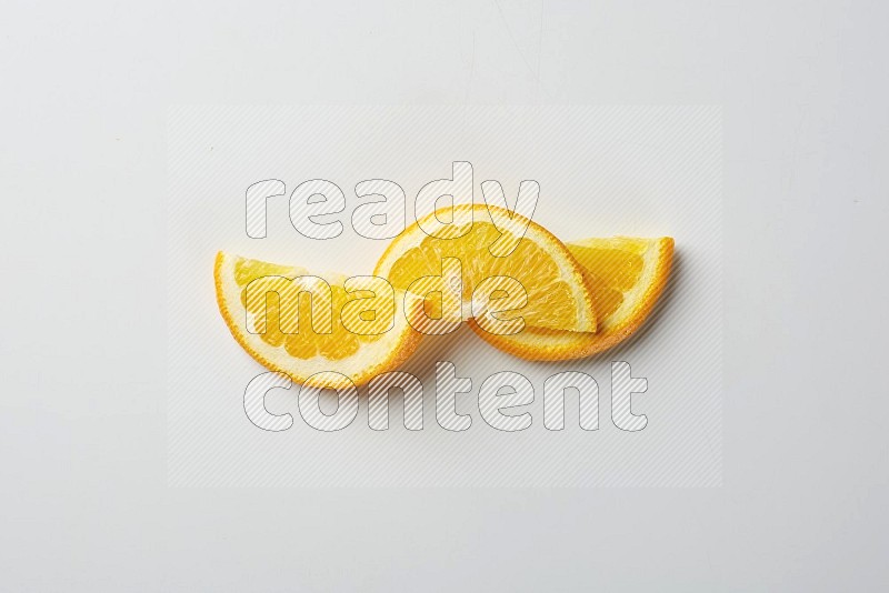 Three halves of an orange slices on white background