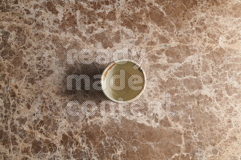 Top View Shot Of A White Pottery bowl On beige Marble Flooring
