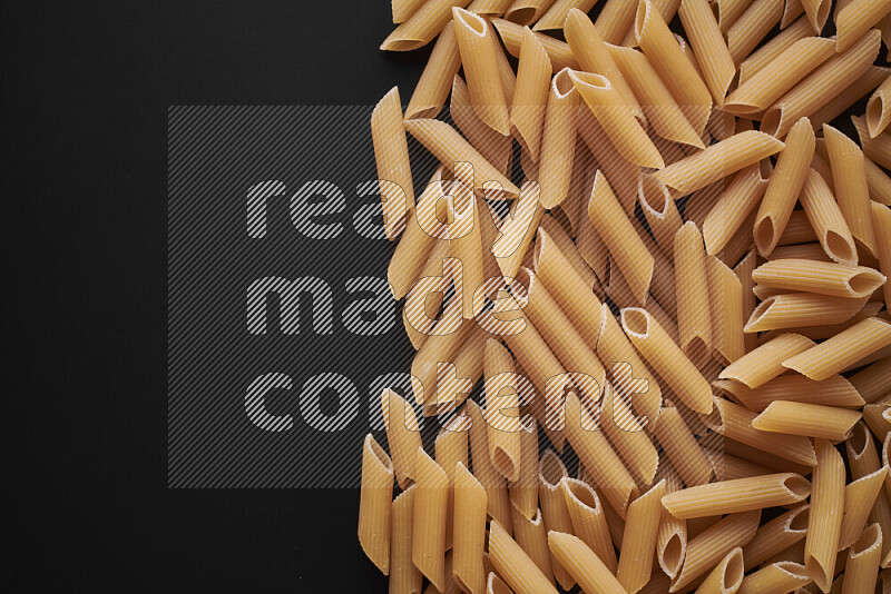 Different pasta types on black background