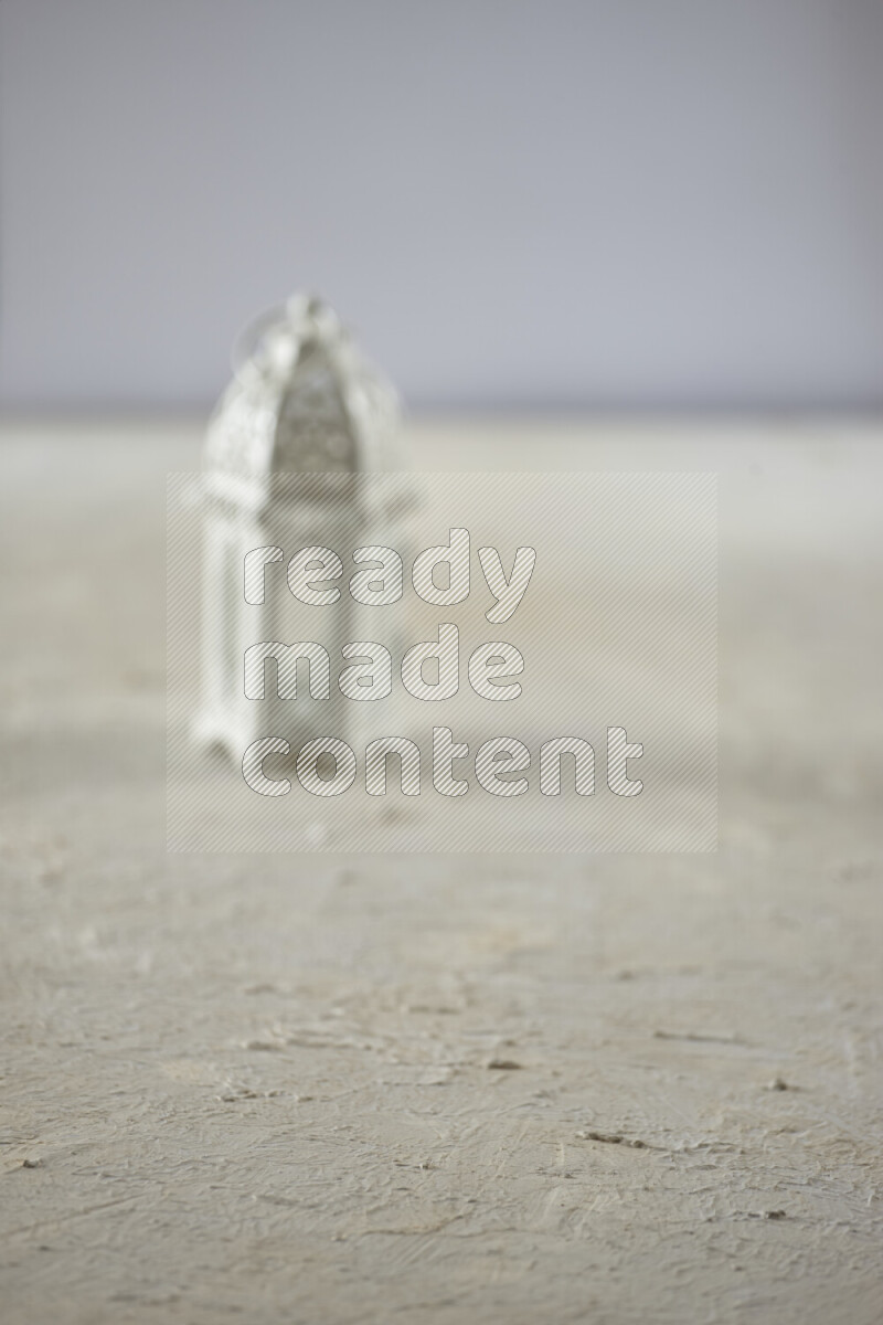 A lantern placed on a textured white background