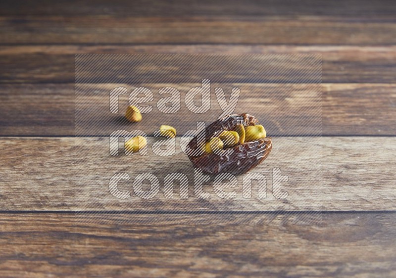 pistachio stuffed madjoul date on a wooden background