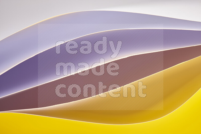 This image showcases an abstract paper art composition with paper curves in purple and gold gradients created by colored light