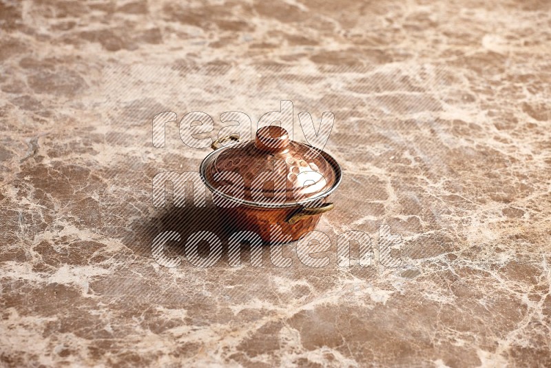 Small Copper Pot on Beige Marble Flooring, 45 degrees