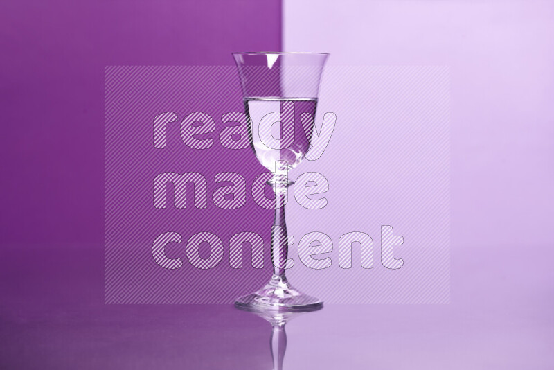 The image features a clear glassware filled with water, set against purple and light purple background