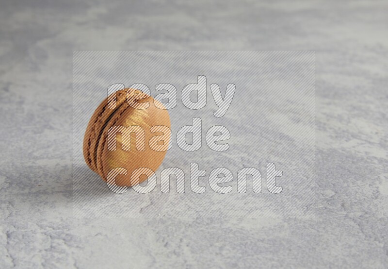 45º Shot of Brown Coffee macaron on white  marble background