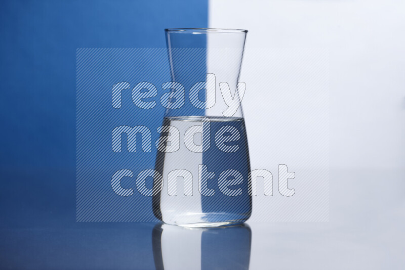 The image features a clear glassware filled with water, set against white and blue background