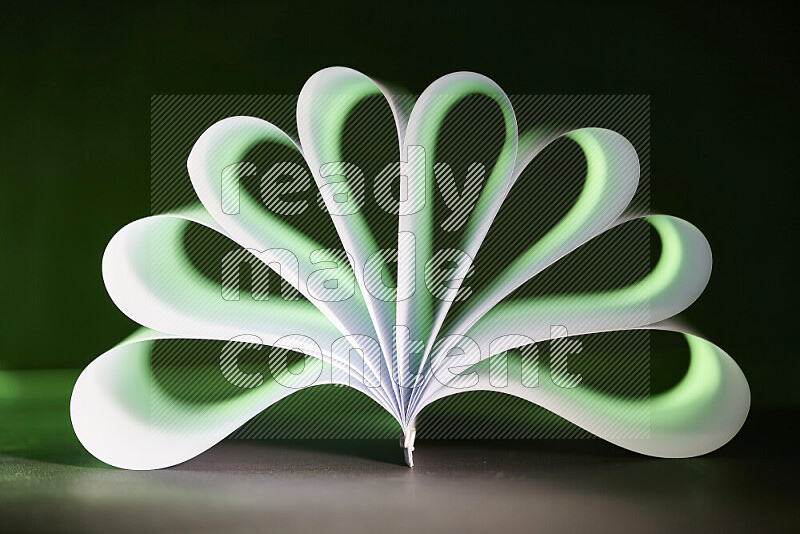 An abstract art piece displaying smooth curves in green and white gradients created by colored light