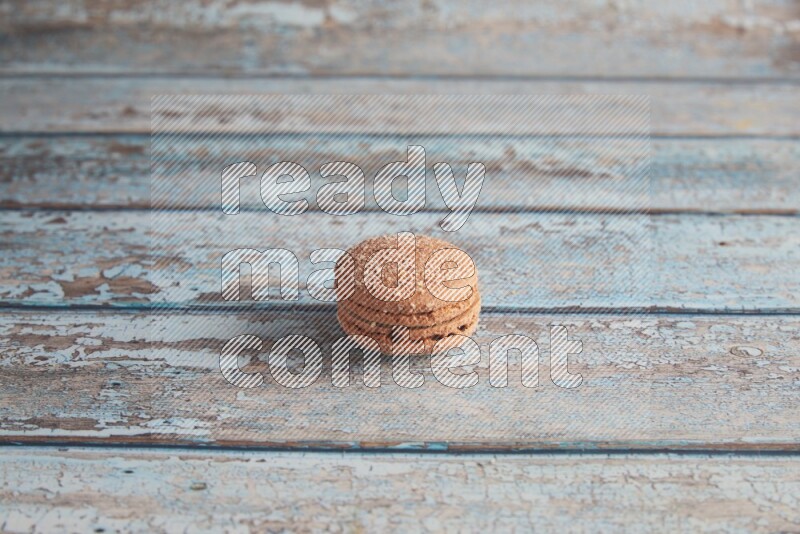 45º Shot of Brown Hazelnuts macaron on light blue wooden background