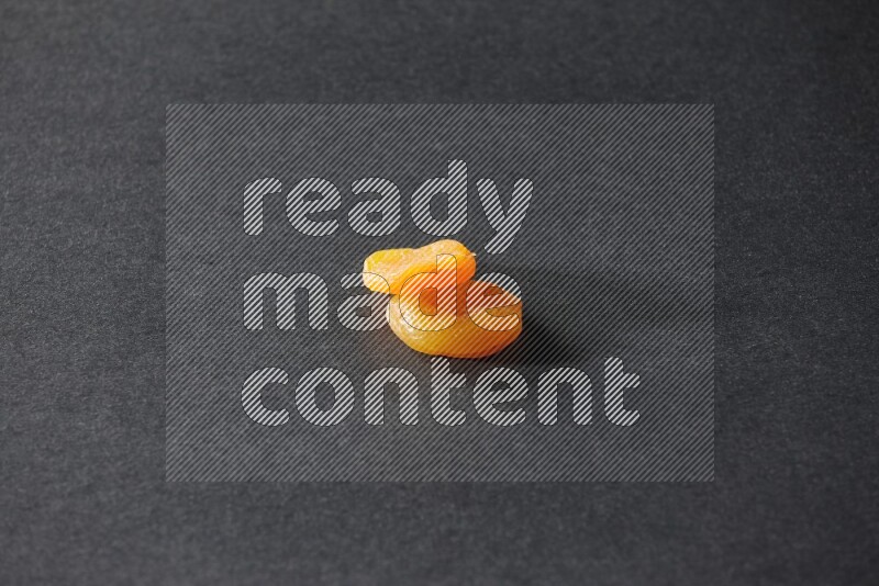 Two dried apricots on a black background in different angles