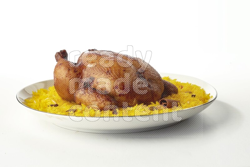 yellow  basmati Rice with kabsa chicken pieces on a white plate with a silver rim direct on white background