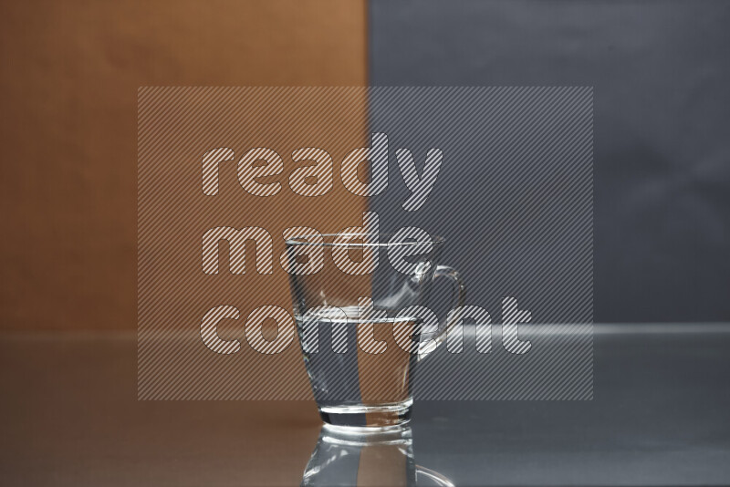 The image features a clear glassware filled with water, set against brown and dark blue background