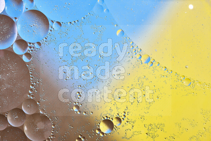 Close-ups of abstract oil bubbles on water surface in shades of yellow, brown and blue