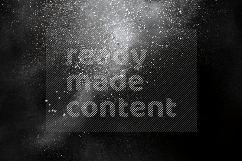 White powder explosion on black background