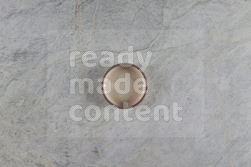 A multicolored pottery oven bowl on grey marble background