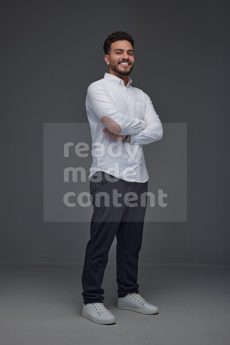 A man wearing smart casual making multi stand poses  eye level on a gray background