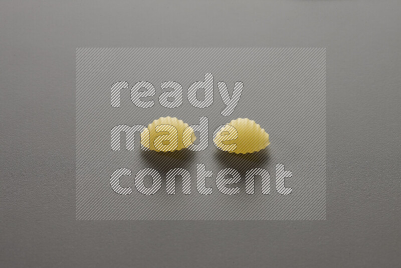 Shells pasta on grey background