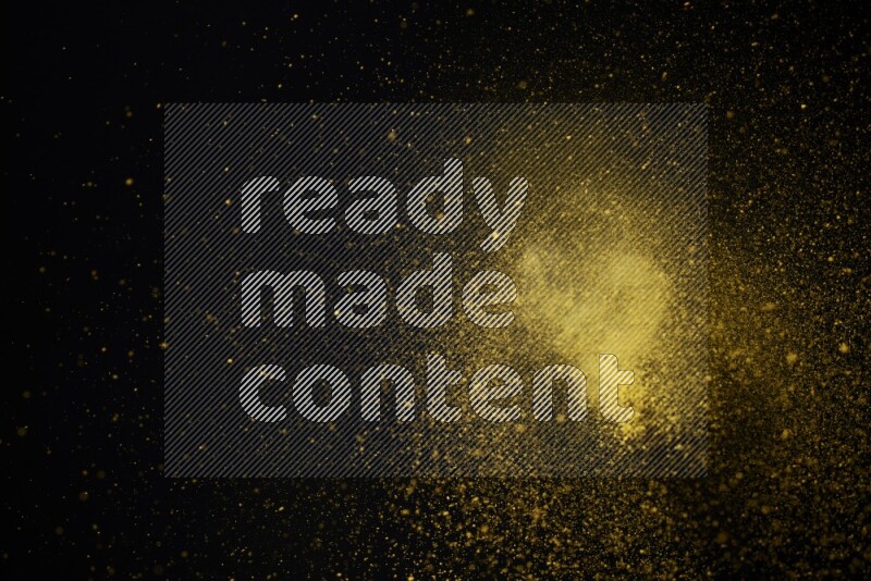 Yellow powder explosion on black background