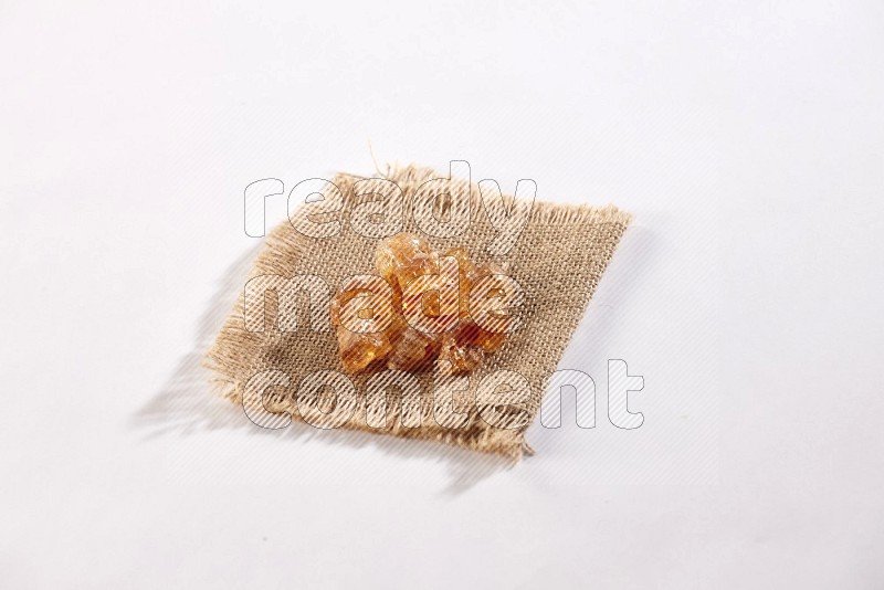 Gum arabic on a burlap piece on white flooring