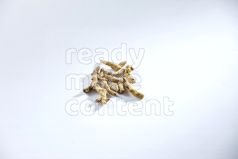 Dried turmeric whole fingers on white flooring