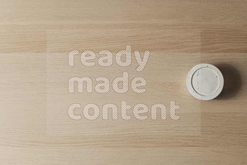 A white pottery bowl on light wooden background