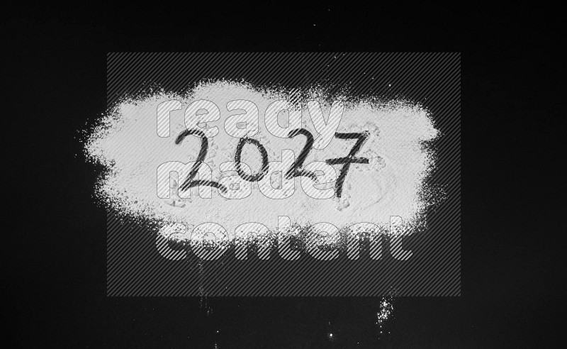 Numbers written with powder on black background