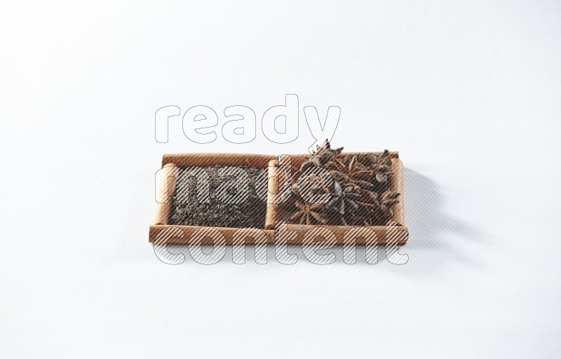 2 squares of cinnamon sticks full of black tea and star anise on white flooring