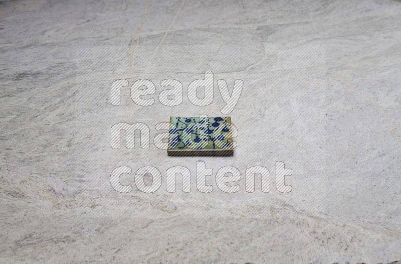 Top view shot of a pottery coaster\ tile on beige marble flooring
