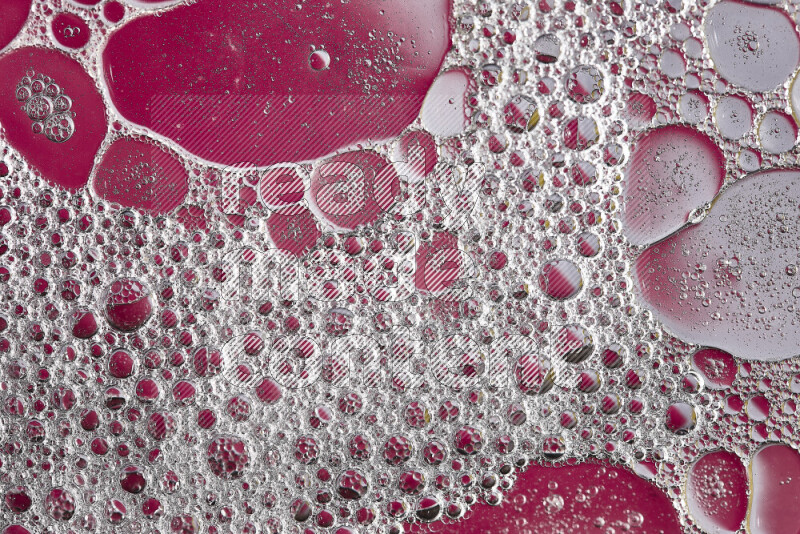 Close-ups of abstract soap bubbles and water droplets on pink background