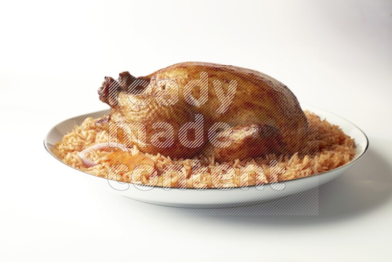 red basmati Rice with whole roasted chicken on a white plate with a silver rim direct on white background
