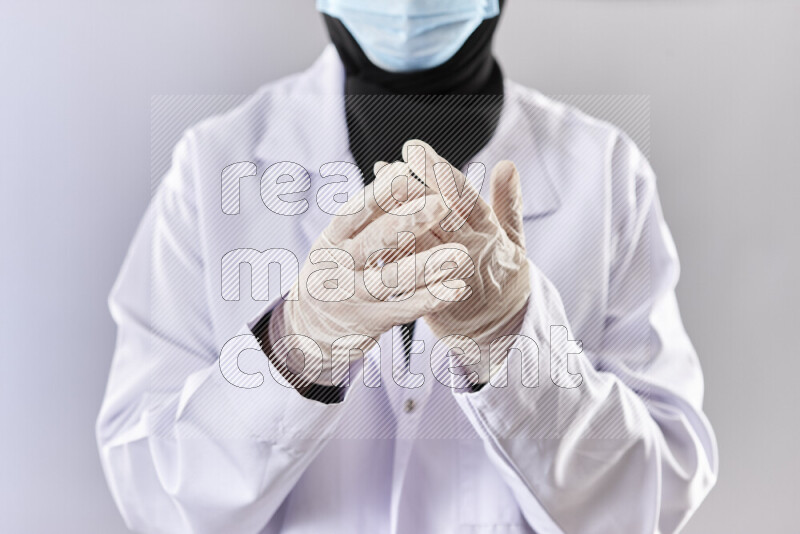 Female doctor wearing an abaya and medical attire in different positions