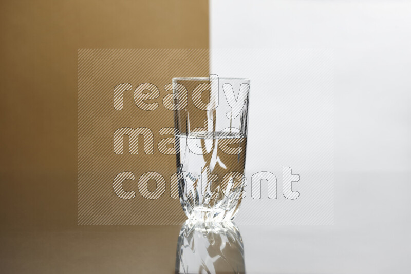 The image features a clear glassware filled with water, set against white and beige background