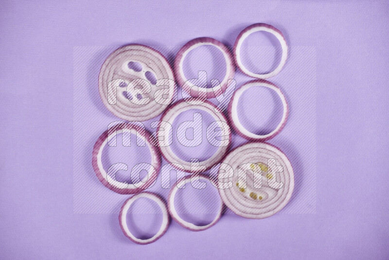 Red onions rings on purple background