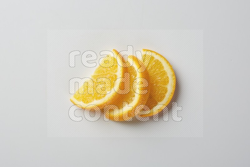 Three halves of an orange slices on white background