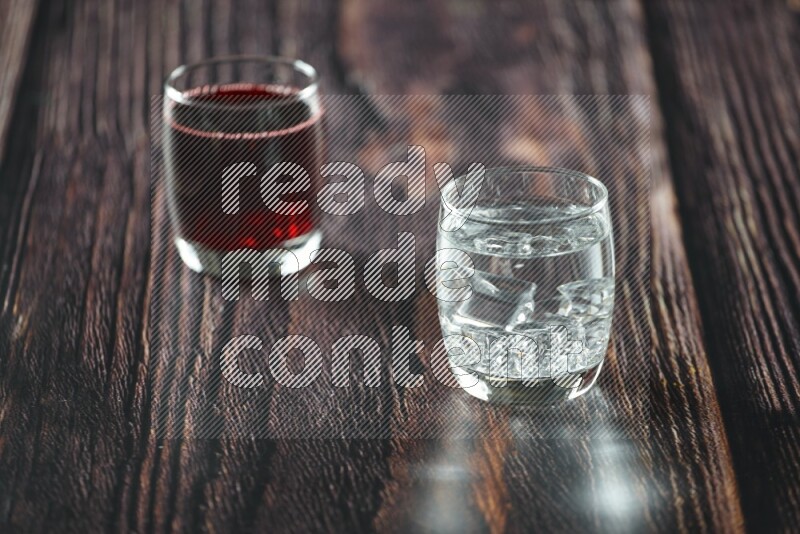 Cold drinks in a glass cup such as water, tamarind, qamar eldin, sobia, milk and hibiscus on wooden background