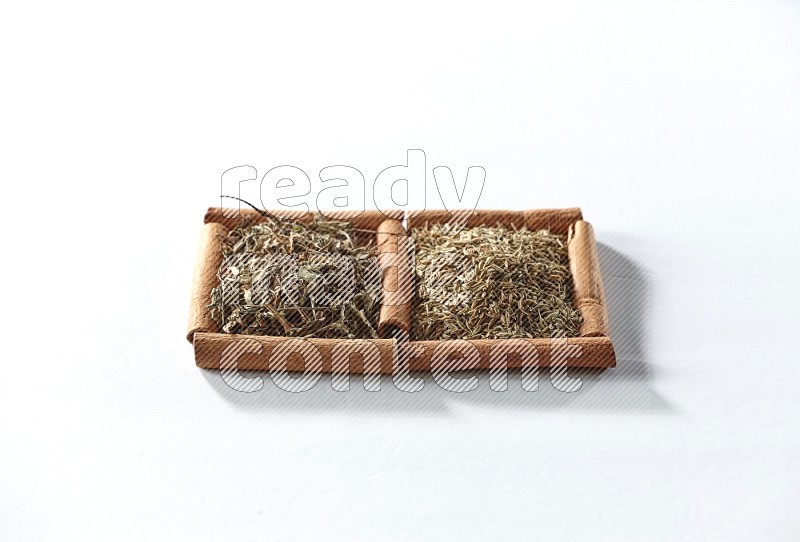 2 squares of cinnamon sticks full of dried basil and cumin on white flooring