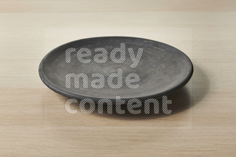 Black Pottery Plate on Oak Wooden Flooring, 15 degrees