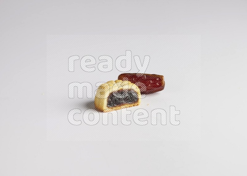 Half Maamoul filled with date with Date on the side direct on white background