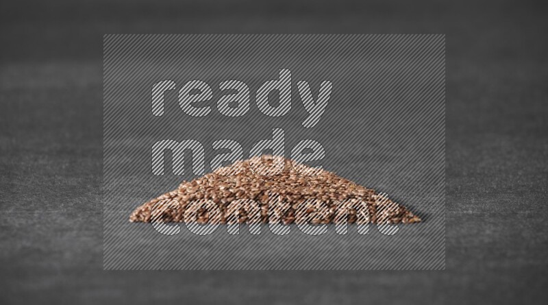 Flax Seeds in a triangle shape on a black Flooring