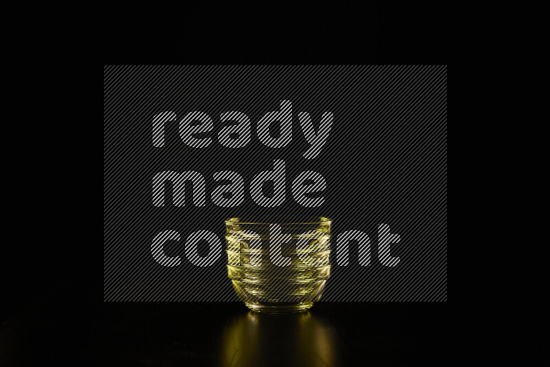 Glassware with rim light in yellow against black background