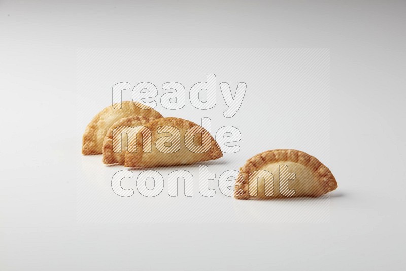 Four fried sambosas on a white background