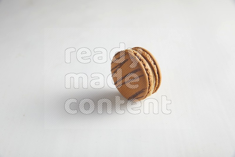45º Shot of light brown  Almond Cream macaron on white background